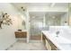 Elegant bathroom features glass shower, stylish fixtures, dual vanities, and an artistic, leafy accent at 2942 Wordsmith Rd, Kissimmee, FL 34746
