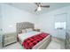 Well-lit bedroom boasts a silver headboard, stone floors, bedside tables, and a Buffalo-plaid blanket at 2942 Wordsmith Rd, Kissimmee, FL 34746
