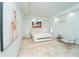 Spacious bedroom with large artwork, travertine floors, and modern furnishings at 2942 Wordsmith Rd, Kissimmee, FL 34746