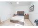 Neutral Primary bedroom featuring a decorative headboard, bedside tables, and stone flooring at 2942 Wordsmith Rd, Kissimmee, FL 34746