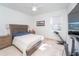 Cozy bedroom with a comfortable bed, ceiling fan, and natural light at 2942 Wordsmith Rd, Kissimmee, FL 34746