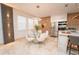 Bright dining room with a glass table, white chairs, and natural light at 2942 Wordsmith Rd, Kissimmee, FL 34746