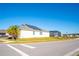 Exterior view of a modern home with solar panels and a screened-in pool area at 2942 Wordsmith Rd, Kissimmee, FL 34746