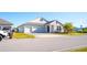 Charming two-story home with a two car garage, stone accents, and a well maintained lawn at 2942 Wordsmith Rd, Kissimmee, FL 34746