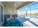 Relax on this screened lanai with water view, comfortable seating, and tasteful decor at 2942 Wordsmith Rd, Kissimmee, FL 34746
