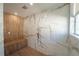 Luxurious marble tiled shower with rainfall showerhead and wooden bench at 2942 Wordsmith Rd, Kissimmee, FL 34746