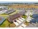 Aerial view of townhomes with lakeside views and ample parking at 2962 Firebush Way, Clermont, FL 34711