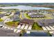 Aerial view of townhomes near a lake and green space in a planned community at 2962 Firebush Way, Clermont, FL 34711