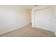 Neutral bedroom featuring beige carpet and a large closet with double doors at 2962 Firebush Way, Clermont, FL 34711