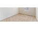 Bright bedroom featuring neutral carpet, trim and paint plus a sunny window at 2962 Firebush Way, Clermont, FL 34711