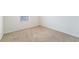 Bedroom with beige carpet and a window with white blinds letting in light at 2962 Firebush Way, Clermont, FL 34711
