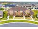 Eye-level aerial view of townhomes with mature trees and landscaping at 2962 Firebush Way, Clermont, FL 34711