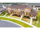 Aerial view of townhomes with manicured lawns and mature landscaping at 2962 Firebush Way, Clermont, FL 34711