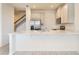 Open kitchen view with white cabinetry, quartz countertops, stainless steel appliances and wood-look tile flooring at 2962 Firebush Way, Clermont, FL 34711