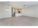Open concept living and kitchen area with wood-look tile flooring, modern ceiling fan, and recessed lighting at 2962 Firebush Way, Clermont, FL 34711