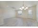 Open living area with wood-look tile flooring, ceiling fan, recessed lighting, and a view of the front door at 2962 Firebush Way, Clermont, FL 34711