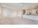 Bright, open-concept living space featuring wood-look tile flooring, open staircase, and stainless steel appliances at 2962 Firebush Way, Clermont, FL 34711