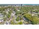 A panoramic aerial shot of a residential area surrounded by lush greenery with a cityscape on the horizon at 3000 Amherst Ave, Orlando, FL 32804