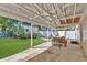 Inviting back patio with covered area, outdoor kitchen, and view of the grassy backyard and shed at 3000 Amherst Ave, Orlando, FL 32804