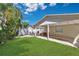 Spacious backyard featuring a covered patio with outdoor seating and lush green lawn at 3000 Amherst Ave, Orlando, FL 32804