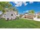 Beautiful backyard showcasing a large shed, green lawn, and a covered outdoor dining space at 3000 Amherst Ave, Orlando, FL 32804