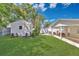Lush backyard with a well-maintained lawn, shed, and covered patio area ideal for outdoor enjoyment at 3000 Amherst Ave, Orlando, FL 32804