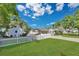 Expansive backyard featuring a white picket fence, lush green grass, mature trees, and a detached shed at 3000 Amherst Ave, Orlando, FL 32804