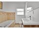 Well-lit bathroom with a soaking tub, updated vanity, and tile flooring at 3000 Amherst Ave, Orlando, FL 32804
