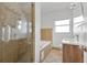 Tiled bathroom with a glass-enclosed shower, soaking tub, and a modern vanity at 3000 Amherst Ave, Orlando, FL 32804