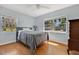 Bright bedroom with wood floors, large windows, and neutral decor at 3000 Amherst Ave, Orlando, FL 32804
