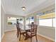 Bright dining room features tile floors, wood table with six chairs, and multiple windows for natural light at 3000 Amherst Ave, Orlando, FL 32804