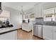 Well-lit kitchen featuring white cabinetry, stainless steel appliances, and tile backsplash at 3000 Amherst Ave, Orlando, FL 32804