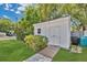 Detached shed in backyard with ramp and adjacent yard waste containers surrounded by greenery at 3000 Amherst Ave, Orlando, FL 32804
