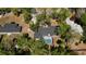 Aerial view of the property with a screened pool and mature landscaping, surrounded by trees at 308 Tangerine St, Altamonte Springs, FL 32701