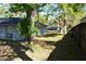 Side yard view with mature trees and partial view of neighboring homes at 308 Tangerine St, Altamonte Springs, FL 32701
