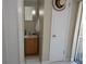 A small bathroom with a vanity, mirror, and a unique hat decor hanging on the wall at 308 Tangerine St, Altamonte Springs, FL 32701