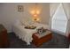 Cozy bedroom with soft carpet, a bed with decorative pillows, and a large window with curtains at 308 Tangerine St, Altamonte Springs, FL 32701