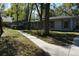 Charming single-story home with well-maintained landscaping, mature trees, and concrete walkway at 308 Tangerine St, Altamonte Springs, FL 32701