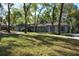 Inviting one-story home with a manicured lawn, concrete walkway, and lush trees enhancing the property's appeal at 308 Tangerine St, Altamonte Springs, FL 32701
