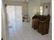 This home office features light tile flooring, natural light, and a traditional wood desk at 308 Tangerine St, Altamonte Springs, FL 32701