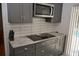 A kitchen with a range cooktop, modern cabinets, and stainless steel microwave at 308 Tangerine St, Altamonte Springs, FL 32701