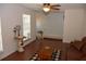 Bright living room featuring wood floors, an leather sofa, and a view to the foyer at 308 Tangerine St, Altamonte Springs, FL 32701