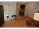 Cozy living room with a stone fireplace, sliding glass doors to the pool, and hardwood flooring at 308 Tangerine St, Altamonte Springs, FL 32701