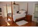 A bright and airy main bedroom features a four-poster bed, ceiling fan, and an ensuite bath at 308 Tangerine St, Altamonte Springs, FL 32701
