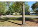 A peaceful street view showcasing mature trees and landscaping with driveway and sidewalk at 308 Tangerine St, Altamonte Springs, FL 32701