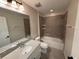 Well-lit bathroom features a single sink vanity and a shower over tub at 3665 Brighton Park Cir, Orlando, FL 32812
