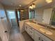 Bathroom featuring double sinks, walk-in shower with glass door and tile surround at 3665 Brighton Park Cir, Orlando, FL 32812