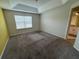 Bedroom featuring carpet flooring, a window, and access to an ensuite bathroom at 3665 Brighton Park Cir, Orlando, FL 32812