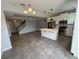 Open living space featuring tile flooring, a kitchen, a staircase, and neutral wall paint at 3665 Brighton Park Cir, Orlando, FL 32812