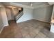 Spacious living room featuring tile flooring, a staircase, and neutral wall paint at 3665 Brighton Park Cir, Orlando, FL 32812